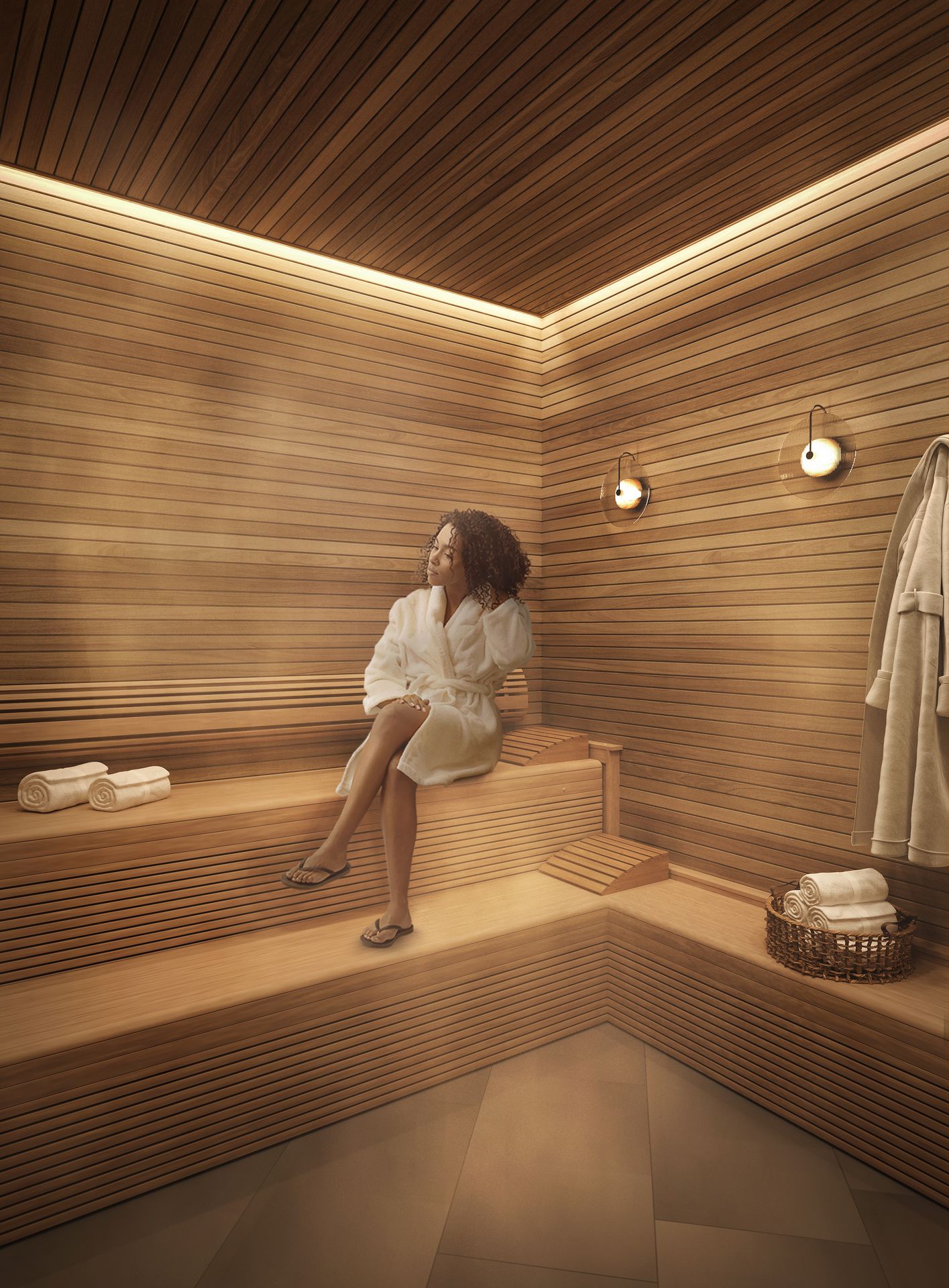 A woman in a white robe relaxes on wooden benches inside a modern sauna in UMich Off-Campus Housing. Rolled towels and a basket are nearby, with robes hanging on the wall. Warm lighting and steam create a soothing atmosphere.
