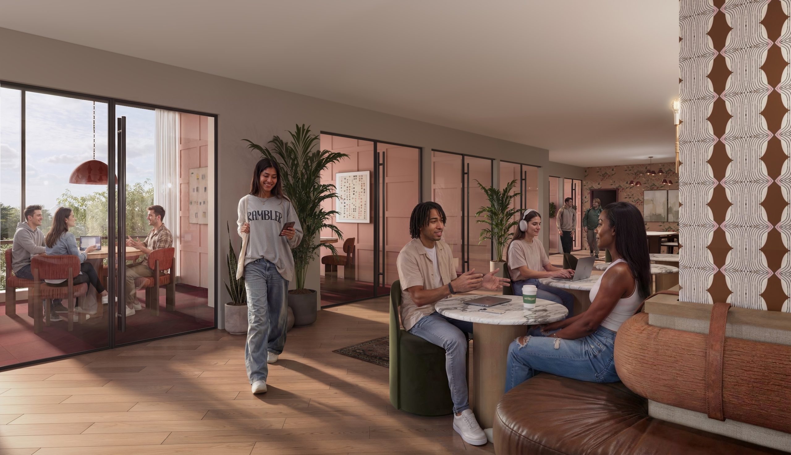 A modern lounge area in UMich Off-Campus Housing with young adults socializing at tables. One woman walks with a drink, while others sit chatting. In the background, more people converse in a glass-walled room with large windows and plants.