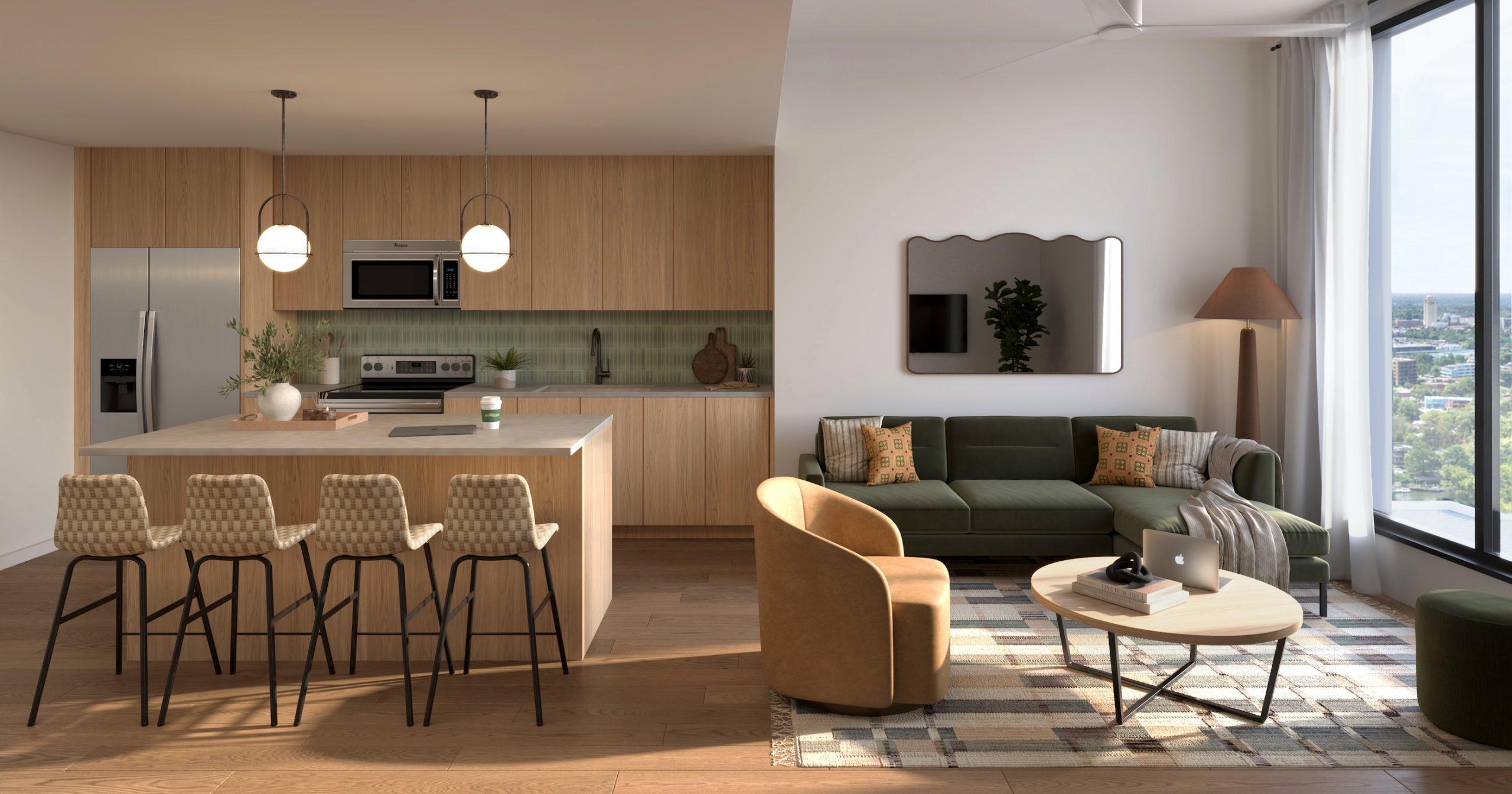 Modern open-concept kitchen and living room in UMich Off-Campus Housing with wood cabinets, island with four stools, green sofa, round coffee table, and large windows filling the space with natural light. A laptop sits on the coffee table.