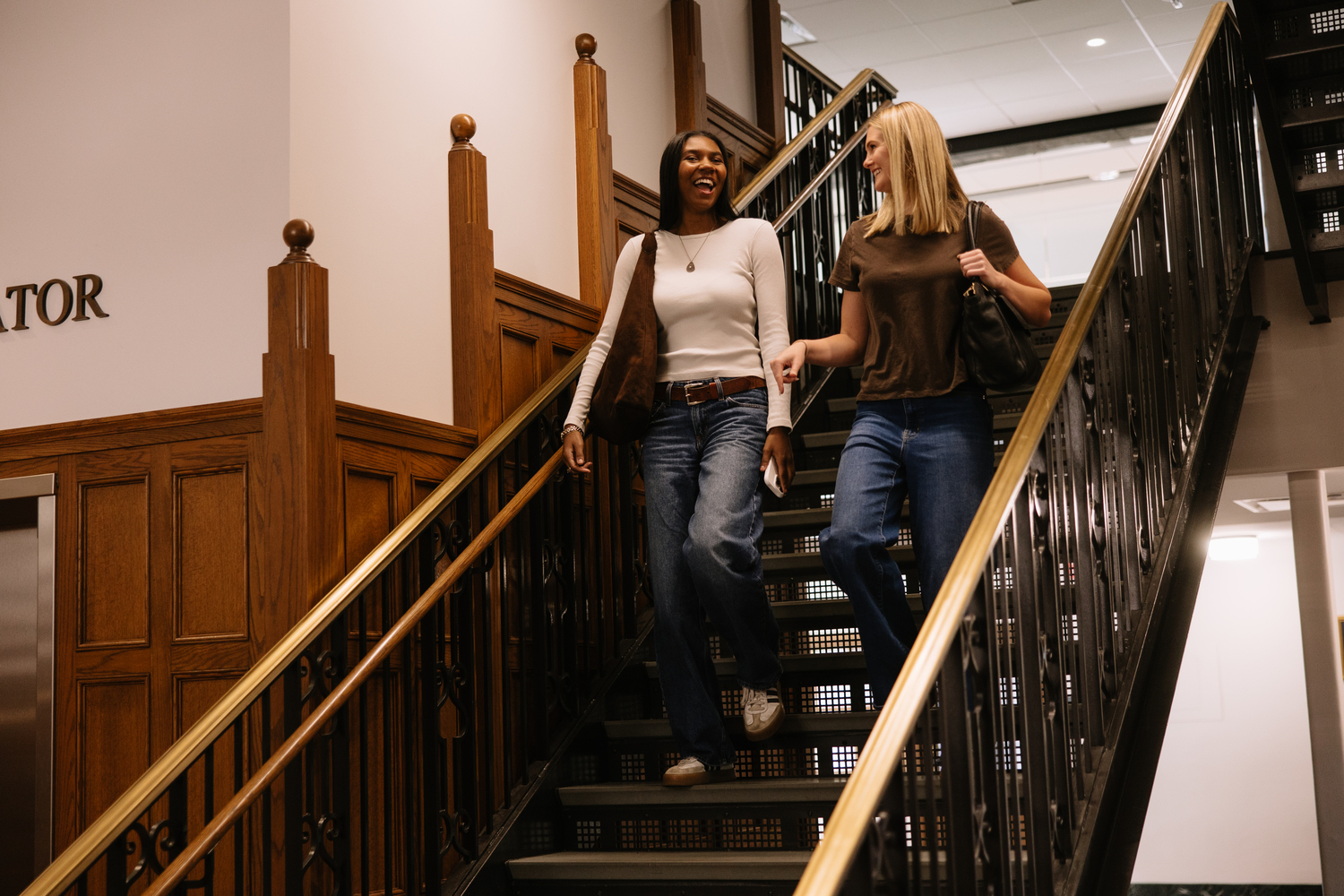 University of Michigan students walking down one of the stairways in the Union, a gathering building on central campus.  