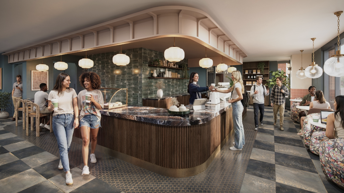 Modern coffee shop in Vic Village North with people socializing; two women walk holding drinks, a barista prepares coffee behind a curved counter, and others sit at tables in a contemporary space with pendant lights and tiled floors.
