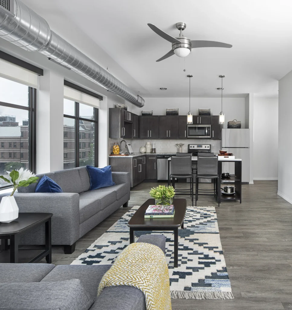 Open-concept kitchen and living room inside a Vic Village North student apartment near the University of Michigan in Ann Arbor.