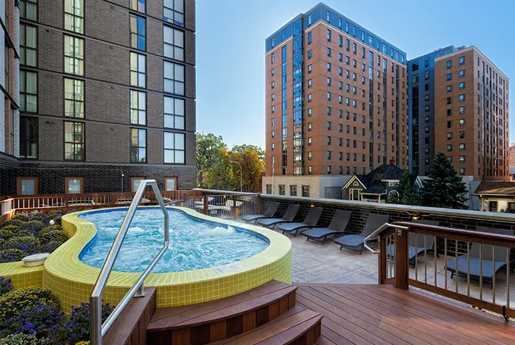 Foundry Lofts Ann Arbor rooftop hot tub and sun deck with lounge chairs, downtown Ann Arbor student housing near the University of Michigan campus.
