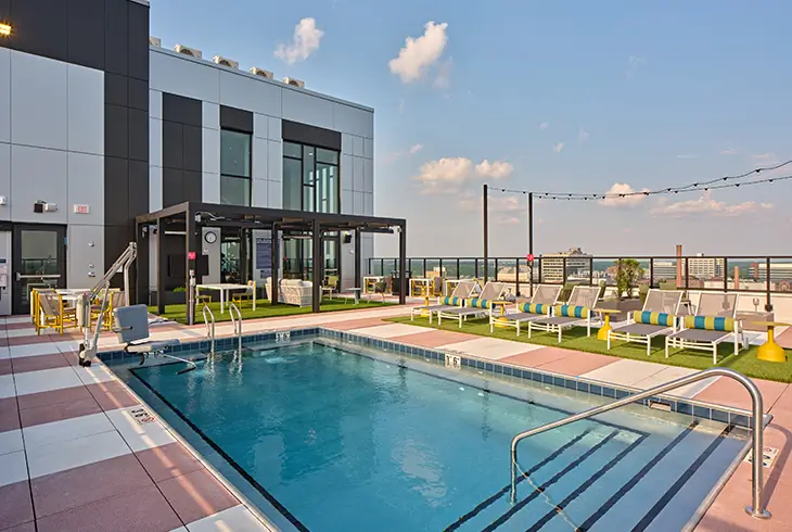 Rooftop pool and lounge deck at The Legacy at Ann Arbor student apartments near the University of Michigan campus.