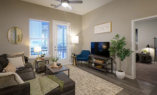 Modern furnished living room at The Legacy at Ann Arbor student apartments near the University of Michigan, featuring sofa, TV, balcony door and hardwood-style flooring.