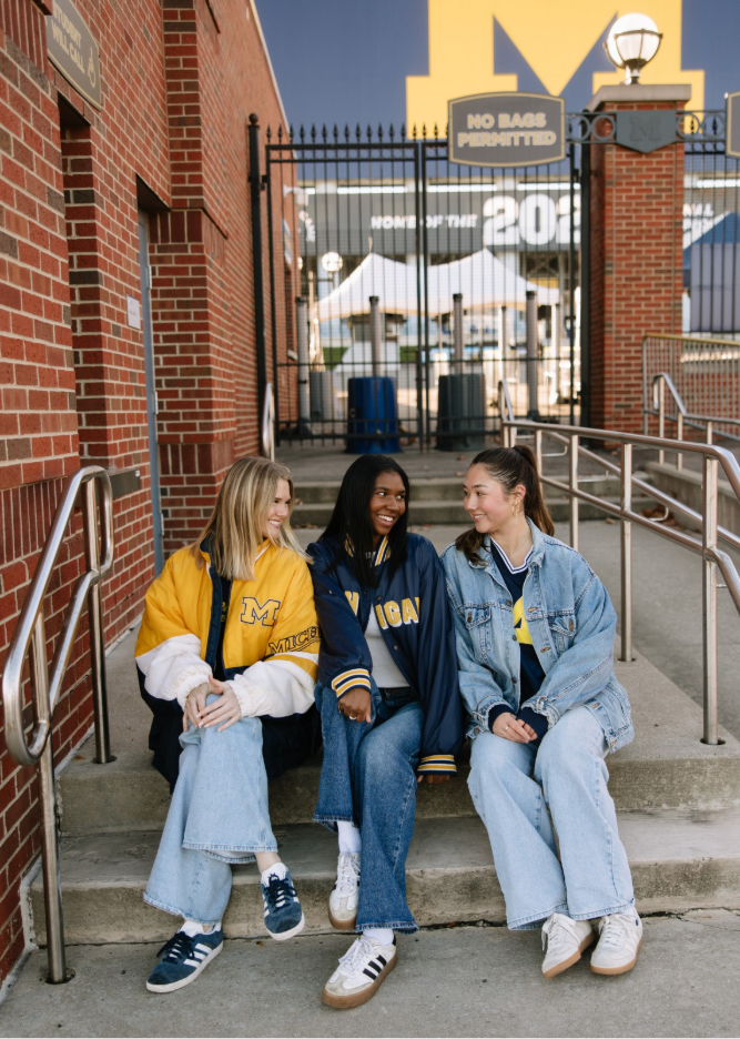 University of Michigan students sit outside of the Big House in Ann Arbor.  
