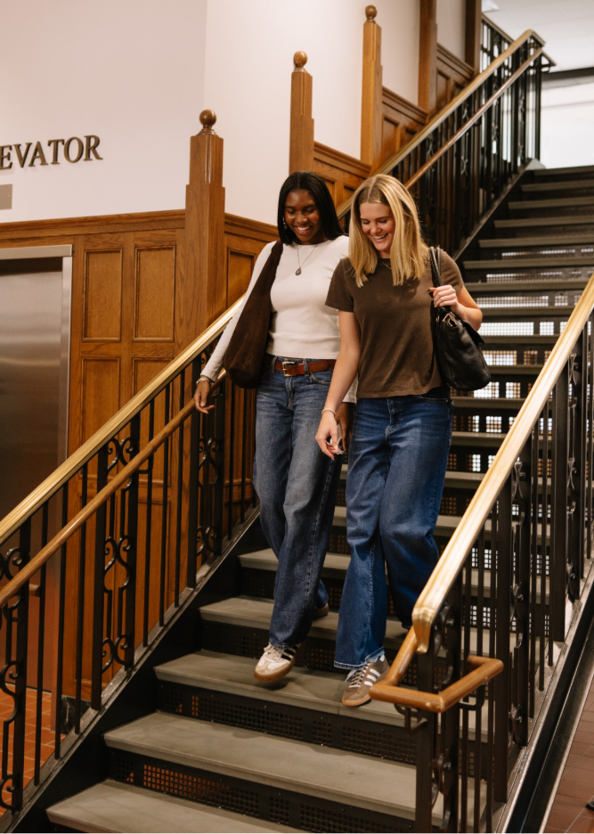Two UMich students walking down the stairs at the Michigan Union, a building located on Central Campus in Ann Arbor.  