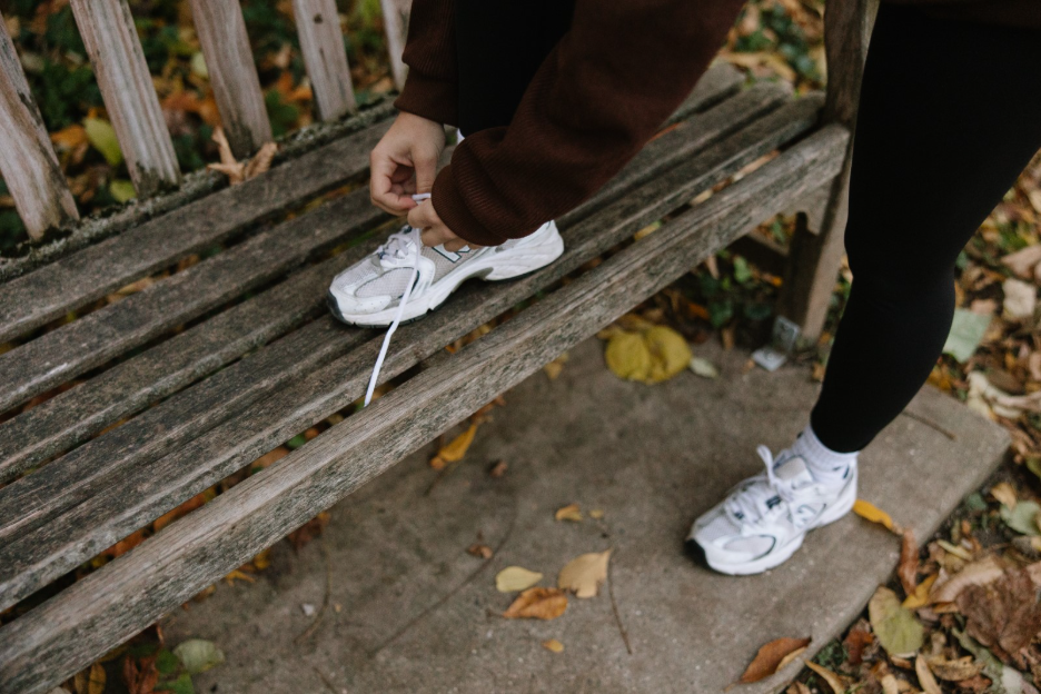 A UMich student laces up their shoes to workout outside in Ann Arbor. 