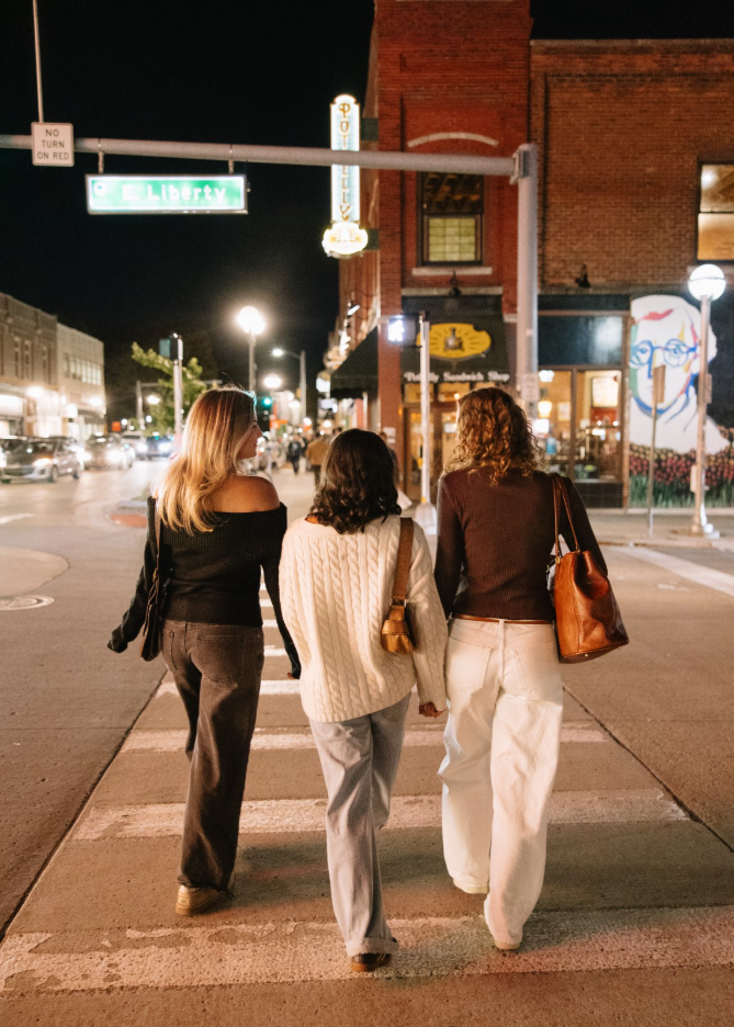 Three University of Michigan students walking around Downtown Ann Arbor near campus.