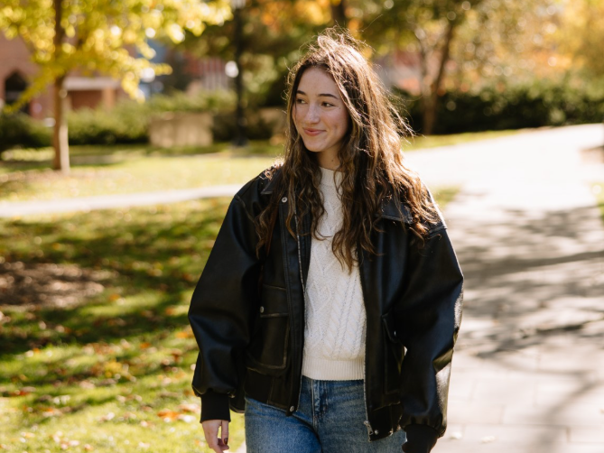 A University of Michigan student walking through the Law Quad, located on Central Campus.