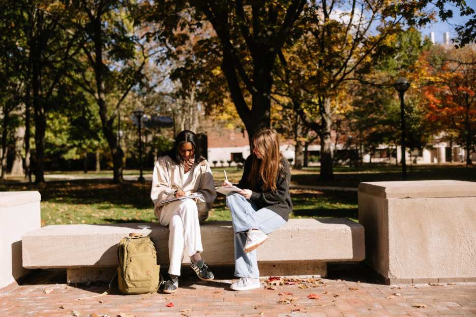 Two UMich students studying in the Diag, a central campus spot in Ann Arbor located near many student apartments.