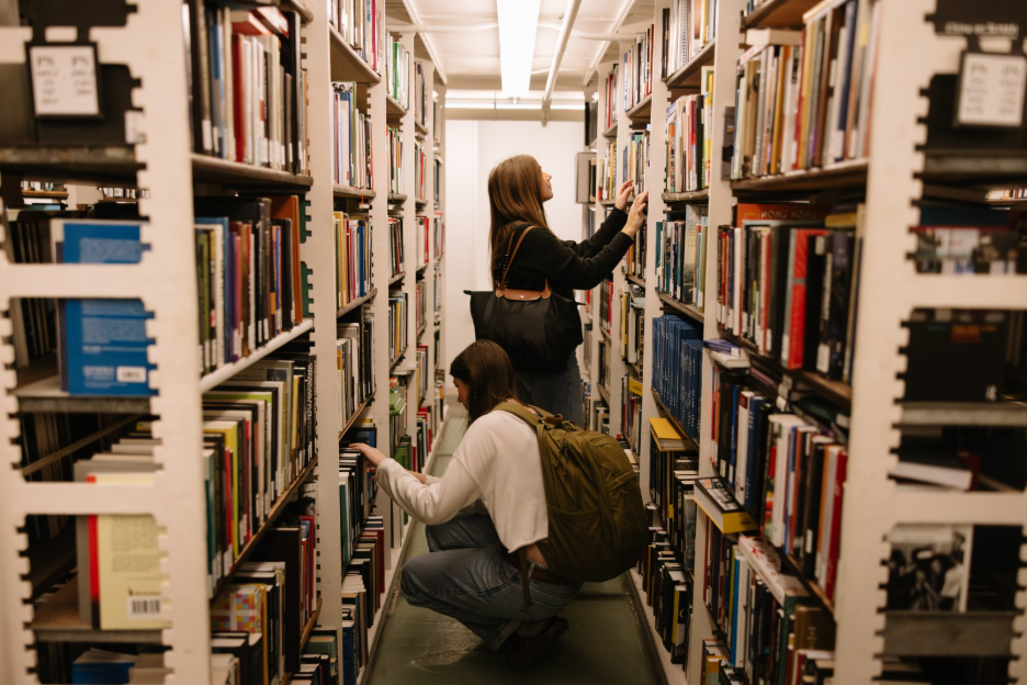 Two UMich students looking for books at the Hatcher Graduate Library, located right off the Diag.