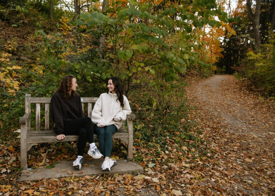 Two UMich students talking in the Nichols Arboretum, a nature reserve in Ann Arbor.