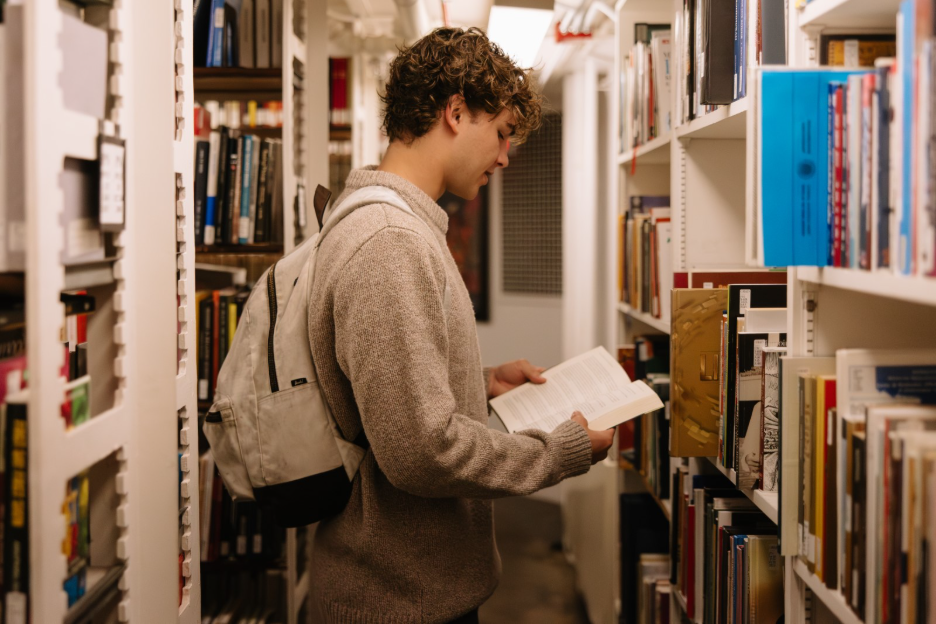 A UMich student reading at the Hatcher Graduate Library, a building located off the Diag in Ann Arbor. 