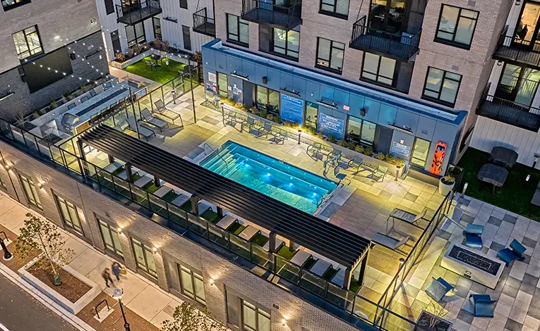 The Standard at Ann Arbor rooftop pool deck with lounge seating and outdoor amenities in modern student apartments near the University of Michigan.