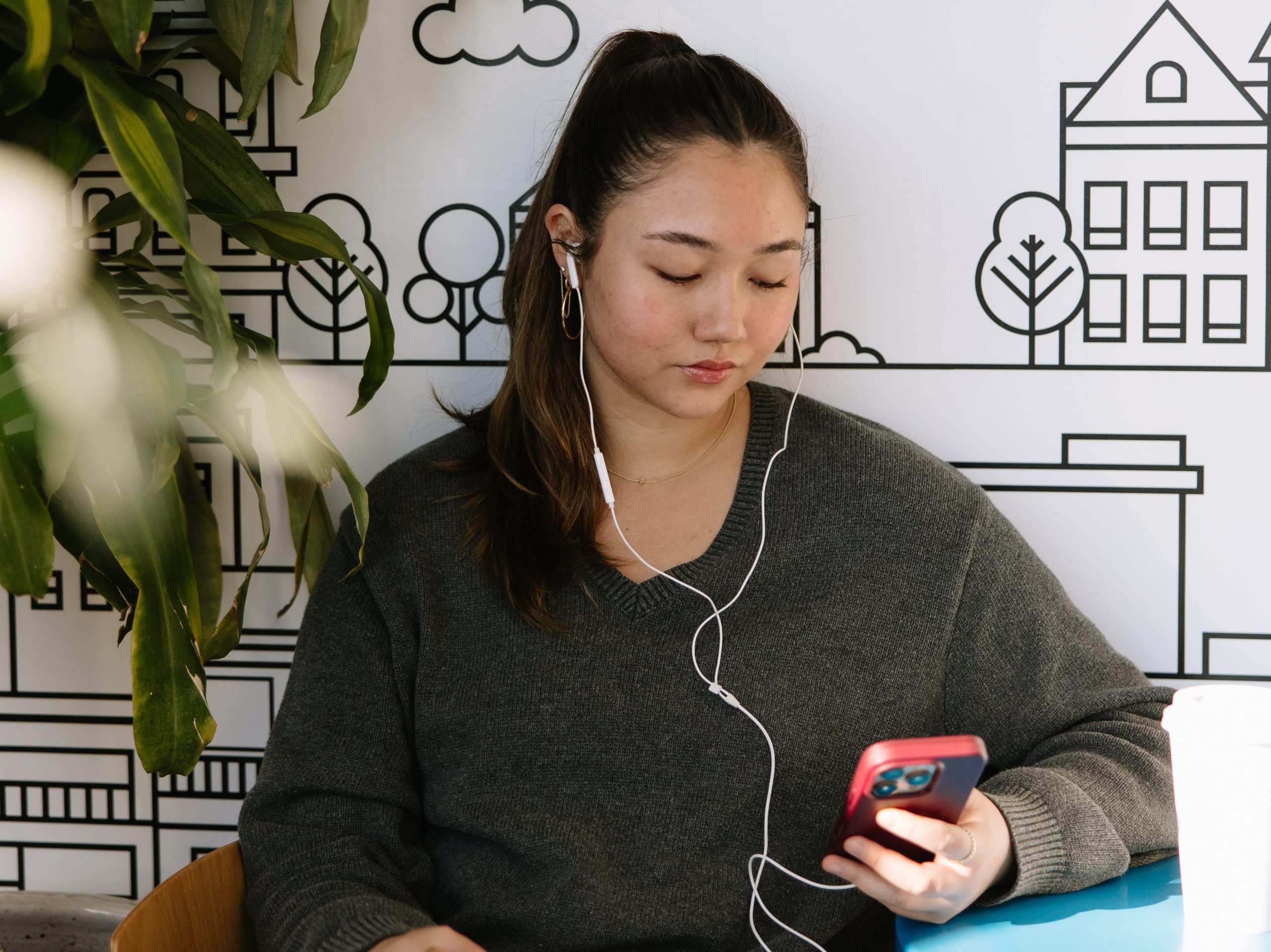 A UMich student looks at her phone on campus in Ann Arbor.