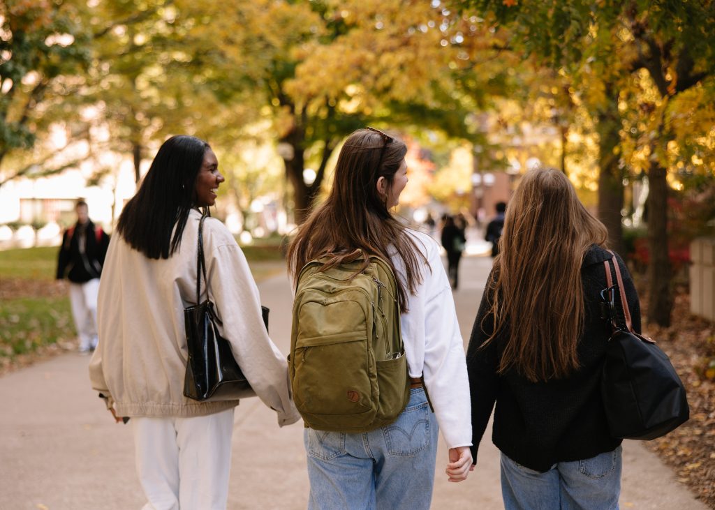 UMich students walk together on campus in Ann Arbor.