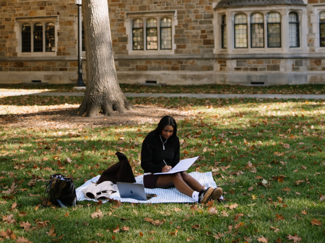 A UMich student studying in the Law Quad near Central Campus in Ann Arbor.