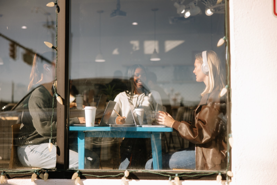 Three UMich students studying in a local coffee shop located off-campus in Ann Arbor.