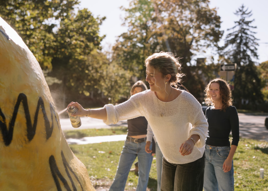 A group of Greek Life students at Michigan spray painting The Rock in Ann Arbor.  