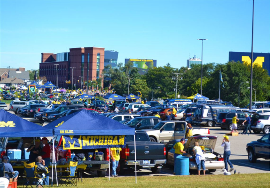 Michigan football fans tailgating at Pioneer High School near the Big House. 