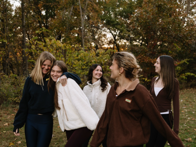 A group of friends walking through the Nichols Arboretum in Ann Arbor.