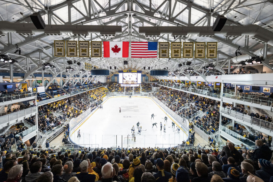 University of Michigan students and fans cheering during a hockey game at Yost Ice Arena.