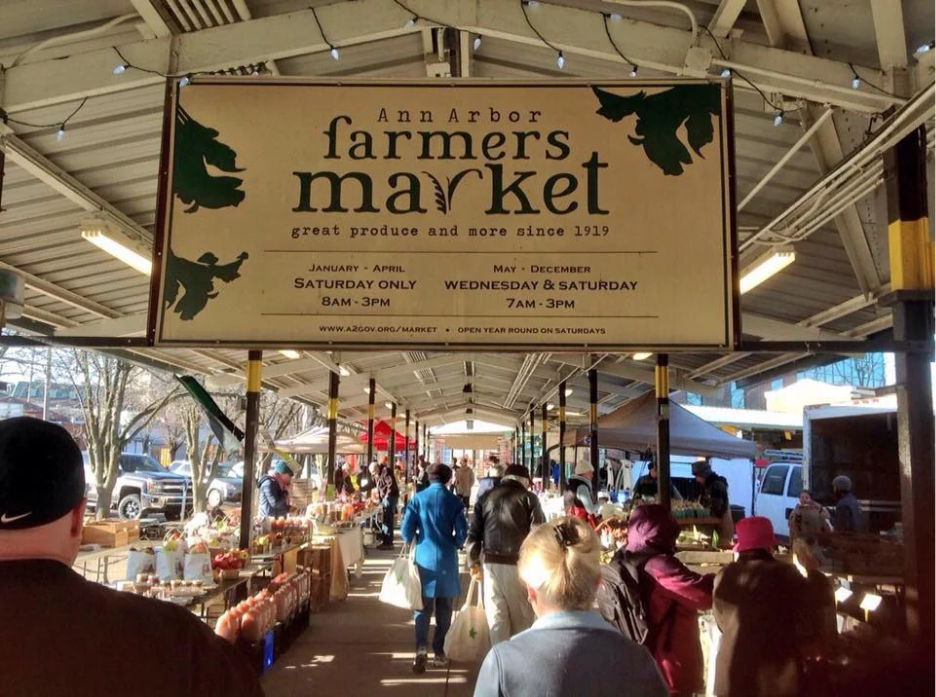 Shoppers browsing vendors at the Ann Arbor Farmers Market in Kerrytown.