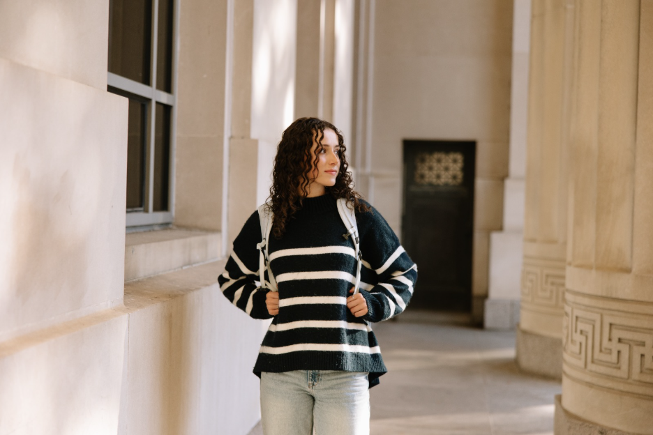 University of Michigan student walking into Angell Hall on Central Campus in Ann Arbor.