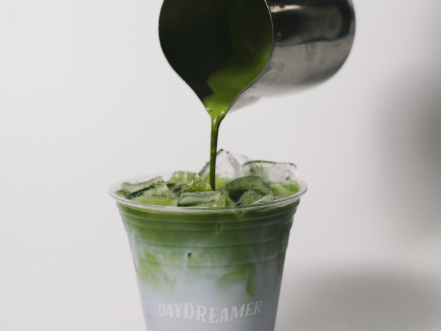 A matcha being poured at Daydreamer Coffee, located inside Rambler Ann Arbor.
