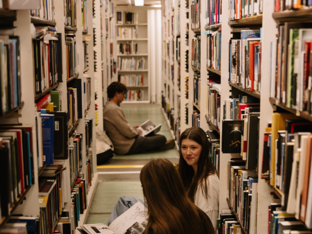 Three UMich students studying in the Hatcher Graduate Library in Ann Arbor.