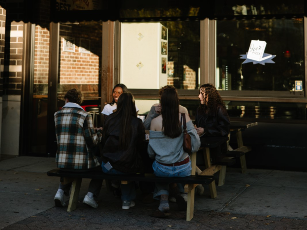 A group of UMich students eating at Joe’s Pizza, a restaurant on Central Campus in Ann Arbor.