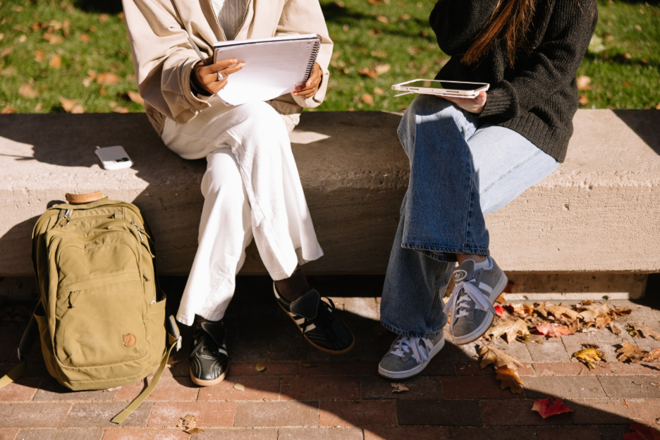 Two University of Michigan students studying in the Diag in Ann Arbor.