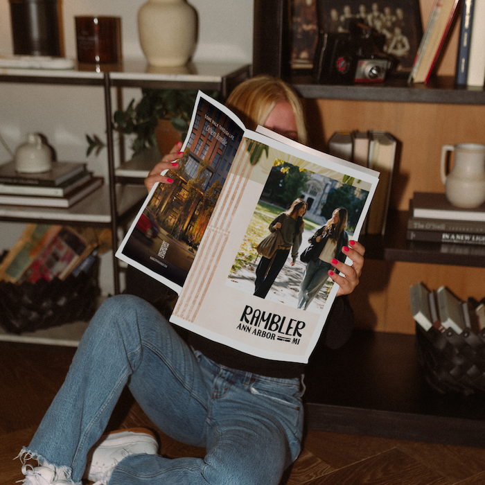 Student reading Ann Arbor Housing Brochure.